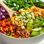 Fresh ingredients for corn and avocado salsa: corn, avocado, red onion, cilantro.